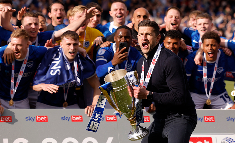 Mousinho celebrating Portsmouth's promotion to the Championship following their League One win